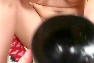Cute teen with a huge black toy